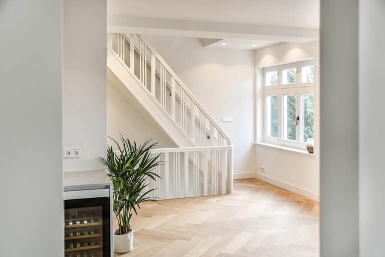 Designed in a minimalistic style staircase hall. Interior of luxury house stair hall